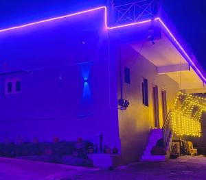 a room with purple lights on the side of a building at Close2heaven 3 bedroom privacy Home with a hall and a paid kitchen in Kodaikānāl