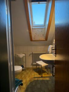 a bathroom with a sink and a toilet and a window at Ferienhaus Spornitz in Mittenwald +64 photos