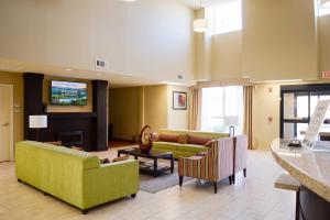 a living room with couches and a flat screen tv at Cotulla Express Inn in Cotulla