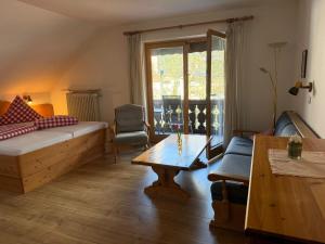 a living room with a couch and a table at Ferienhaus Spornitz in Mittenwald
