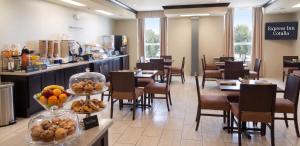 a dining room with tables and chairs and fruit on display at Cotulla Express Inn in Cotulla