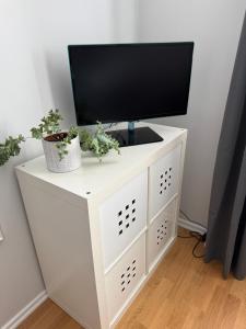a tv on top of a white tv stand at Morfslottet in Gothenburg