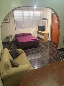 a living room with a couch and a bed at Joe's Studio in San Juan