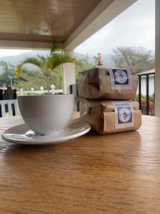 a cup of coffee on a table with a bag at Hotel Central Boquete in Boquete