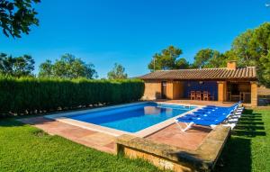 a swimming pool with lounge chairs and a house at Can Moleta in Cala Mendia +52 photos