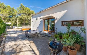 a house with a table and some plants in front of it at Amedart in Alcudia
