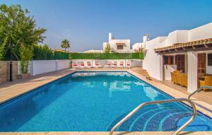 a swimming pool in the backyard of a house at Murta 26 in Sa Coma +44 photos