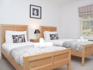 two twin beds in a bedroom with a window at 5 Bed in Colintraive oc-74117 in Colintraive