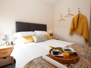 a bedroom with a bed with a tray of food on it at 2 Bed in Richmond oc-74284 in Reeth