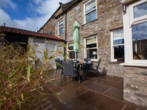 a patio with a table and chairs and an umbrella at 2 Bed in Richmond oc-74284 in Reeth