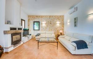 a living room with a white couch and a fireplace at Kiana in Santa Eugenia +30 photos