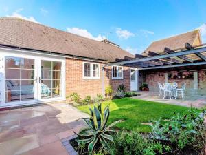 a brick house with a patio and a garden at 1 Bed in Wadhurst oc-79495 in Ticehurst