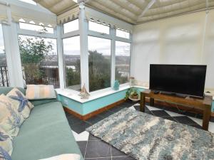 a living room with a couch and a flat screen tv at 1 Bed in Goodwick oc-fb274 in Goodwick