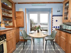 a kitchen with a table and chairs and a window at 1 Bed in Goodwick oc-fb274 in Goodwick