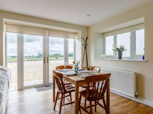 a dining room with a table and chairs and windows at 1 Bed in Corsham oc-83690 in Box +7 photos