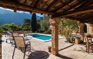 a patio with chairs and a swimming pool at Frontera in Sóller