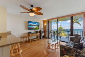 a kitchen and living room with a view of the ocean at Maalaea Banyans Oceanfront in Wailuku