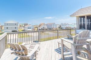 a deck with two chairs and a table on it at Carolina Kai, Kitty Hawk MP 3, 275 Yds to Beach, Ocean View, Pool, Hot Tub, Flex Stays in Kitty Hawk