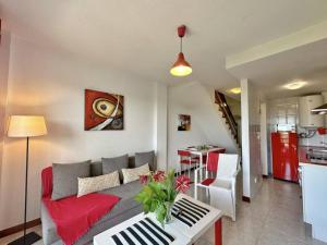 a living room with a couch and a table at Duplex primera linea La Arena 4607 in Arnuero
