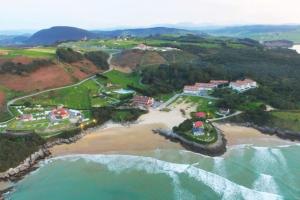 an aerial view of a resort near the ocean at Duplex primera linea La Arena 4607 in Arnuero