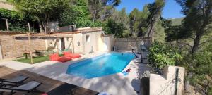 a swimming pool in a backyard with a house at Villa Palama in Marseille