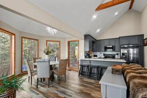 a kitchen and living room with a table and chairs at Hillside Happiness GameRoom Grill Firepit MORE in Sevierville
