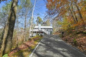 a road leading to a building in the woods at Hillside Happiness GameRoom Grill Firepit MORE in Sevierville