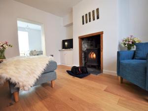 a living room with a couch and a fireplace at 2 Bed in Bideford oc-75307 in Appledore