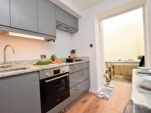 a kitchen with stainless steel appliances and a large window at 2 Bed in Bideford oc-75307 in Appledore +8 photos