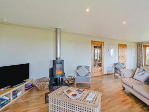 a living room with a couch and a fireplace at 3 Bed in Gordon oc-82788 in Gordon