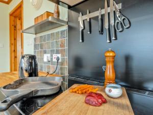 a kitchen with a counter with a cutting board with carrots at 3 Bed in Gordon oc-82788 in Gordon +22 photos