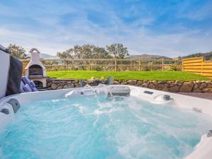 a hot tub with a water fountain in a yard at 1 Bed in Conwy oc-95221 in Conwy