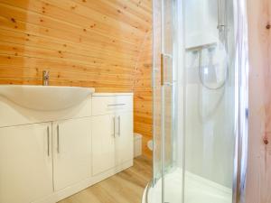 a bathroom with a white sink and a shower at 1 Bed in Conwy oc-95221 in Conwy +14 photos