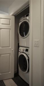 a washing machine and a washer and dryer in a room at Walk to Willard Beach in South Portland