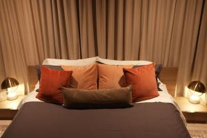 a bed with a bunch of pillows on it at Studio 27 in Magog-Orford