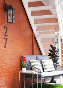 a patio with a bench and a brick wall at Studio 27 in Magog-Orford