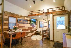 a room with a wooden wall with a table and chairs at Teton Tiny Home | Jackson, Targhee, Yellowstone in Victor