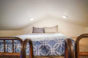 a bedroom with a bed with a blue and white comforter at Teton Tiny Home | Jackson, Targhee, Yellowstone in Victor