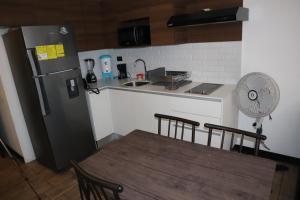 a kitchen with a refrigerator and a table with chairs at EON one bedroom aparment 905 in Estación Pamplona