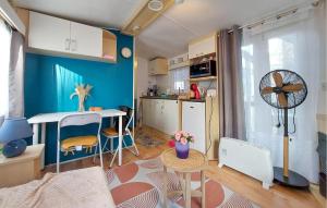 a small apartment with a kitchen and a room with a table at Lovely Stacaravan In La Tremblade in La Tremblade