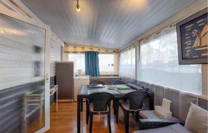 a small dining room with a table and chairs at Lovely Stacaravan In La Tremblade in La Tremblade