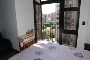 a bedroom with a bed and a window with a view at EON one bedroom aparment 905 in Estación Pamplona