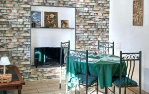 a dining room with a table and a fireplace at Location Cosy De Plain-Pied in Audincourt