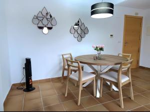 a dining room with a wooden table and chairs at Jazmin ID300 in Villanueva de Río Segura