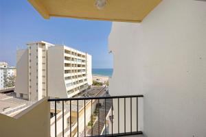 a balcony with a view of the ocean and buildings at Casinha da Praia da Rocha in Praia da Rocha