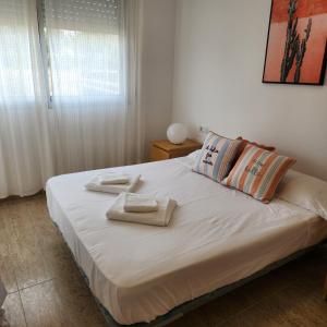 a bedroom with a bed with towels on it at Cala Llobeta in Calafat +35 photos