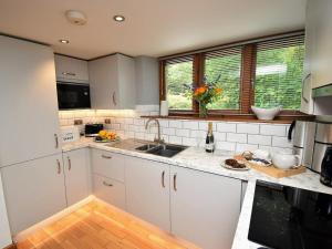 a kitchen with white cabinets and a sink at 1 Bed in Windermere oc-lcc57 in Ings