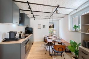 a kitchen and dining room with a table and chairs at Kaisers Anwesen in Vogtsburg