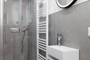 a bathroom with a sink and a shower at Kaisers Anwesen in Vogtsburg +37 photos