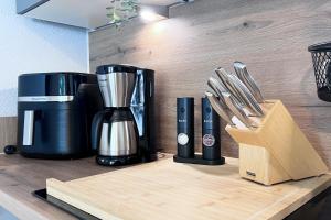 a coffee maker and utensils on a kitchen counter at Emsland-Hus WG2 in Niederlangen
